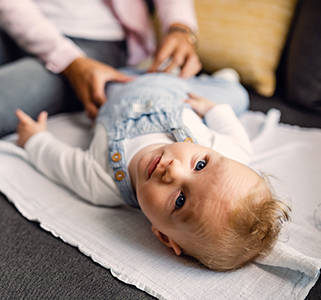 blueeyed-baby-boy-lying-on-the-sofa-and-looking-at-camera-while-time-with-his-mother-at-home